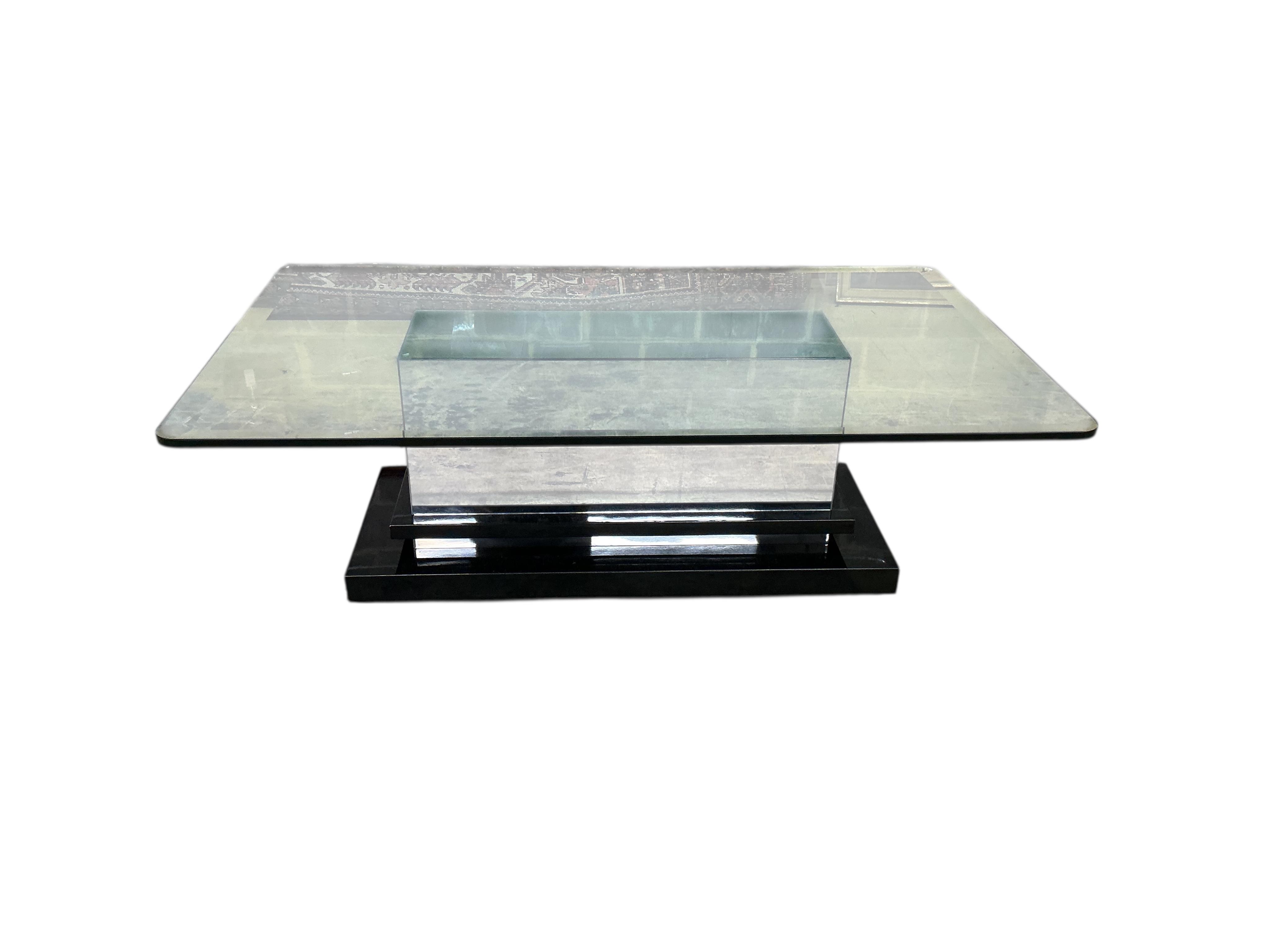 A Contemporary rectangular glass coffee table on mirrored, ebonized plinth base, width 140cm, depth 84cm, height 46cm